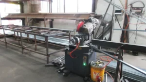 an industrial metal cutting machine at SUN-Carts factory cutting steel tubing for electric golf cart chassis