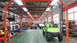 the final quality check station at SUN-Carts production line where technicians inspect finished electric golf carts before shipping
