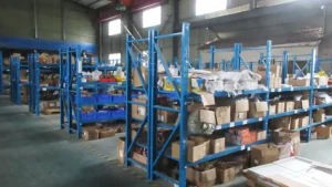material staging area next to the assembly line at SUN-Carts factory with organized bins containing electric cart components
