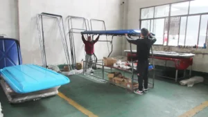 quality inspector checking the roof panel fitment and sealant on a SUN-Carts electric golf cart at the production line
